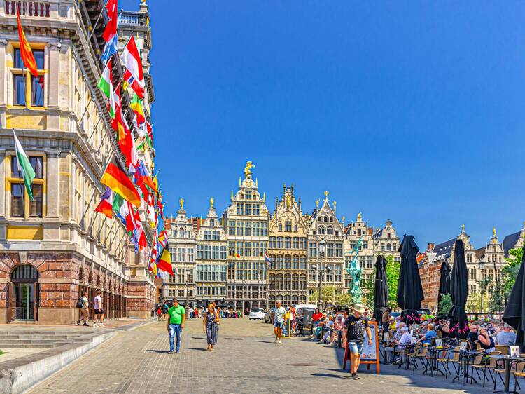 City Hall Stadhuis, guildhalls guild houses and street restaurants cafes with people tourists on Grote Markt Big Market Square in old town Antwerpen historical centre