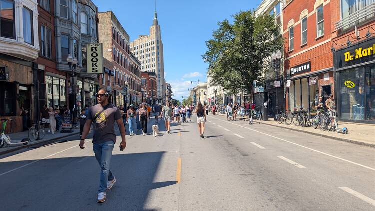 Throngs of people walk along a car-less Milwaukee Avenue.