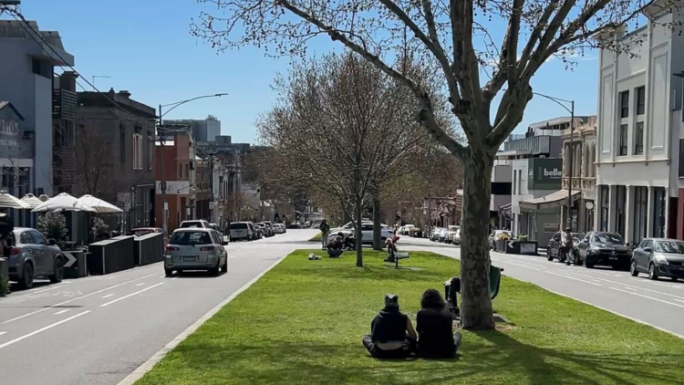 Two people sitting on the nature strop in North Melbourne.