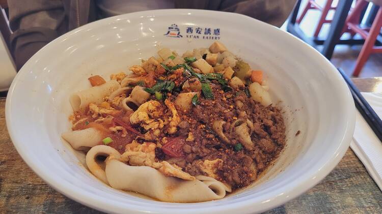 A bowl of biang biang noodles with pork mince