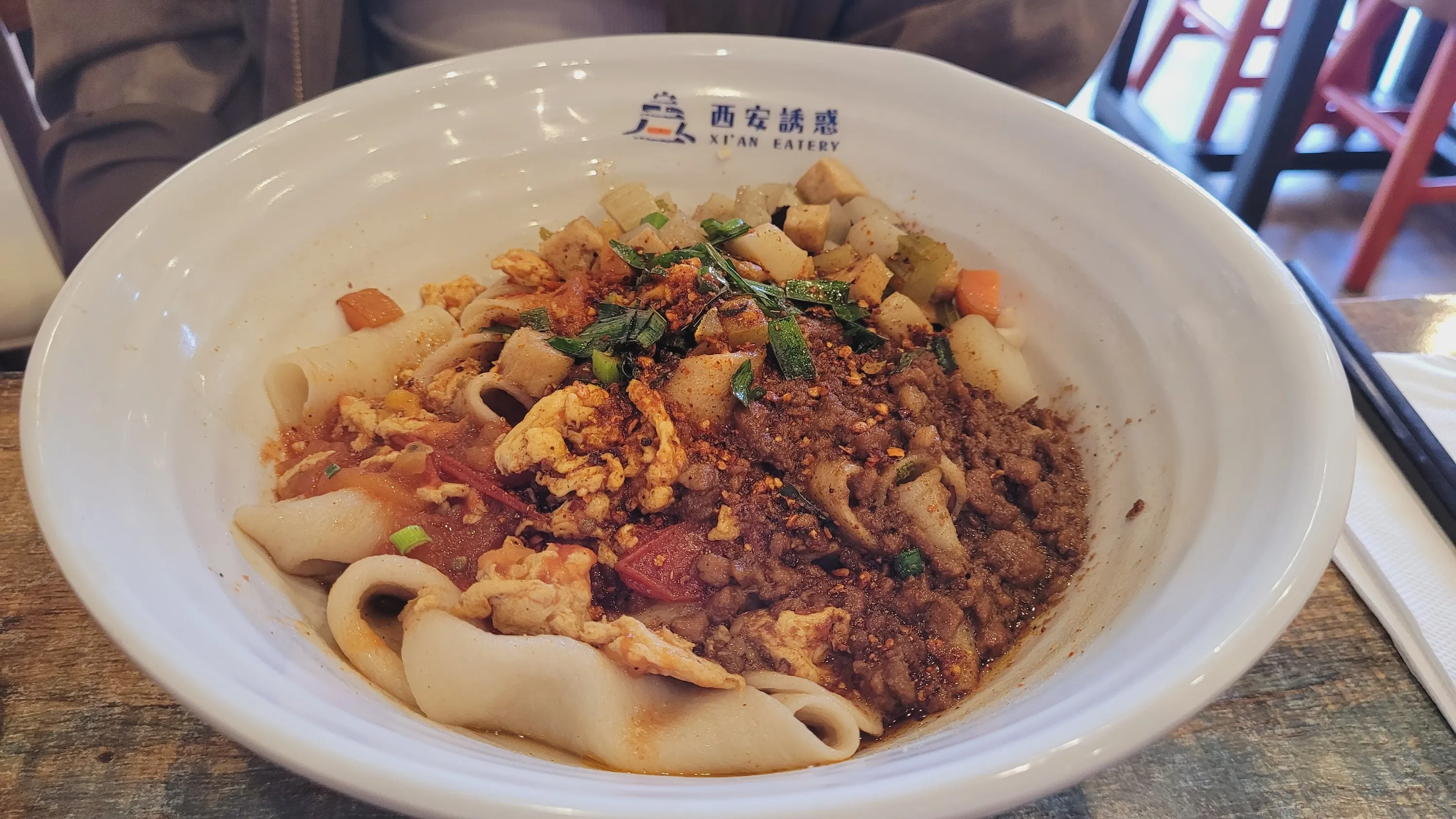 A bowl of biang biang noodles with pork mince