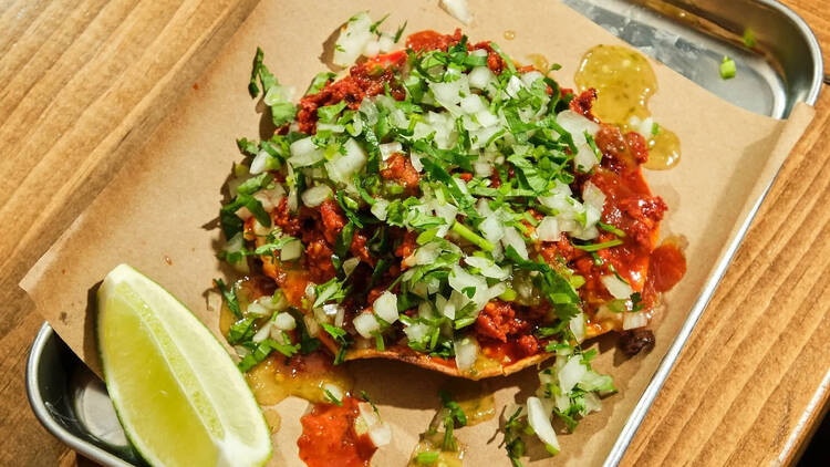 Tacos with cilantro, onions and a lime wedge