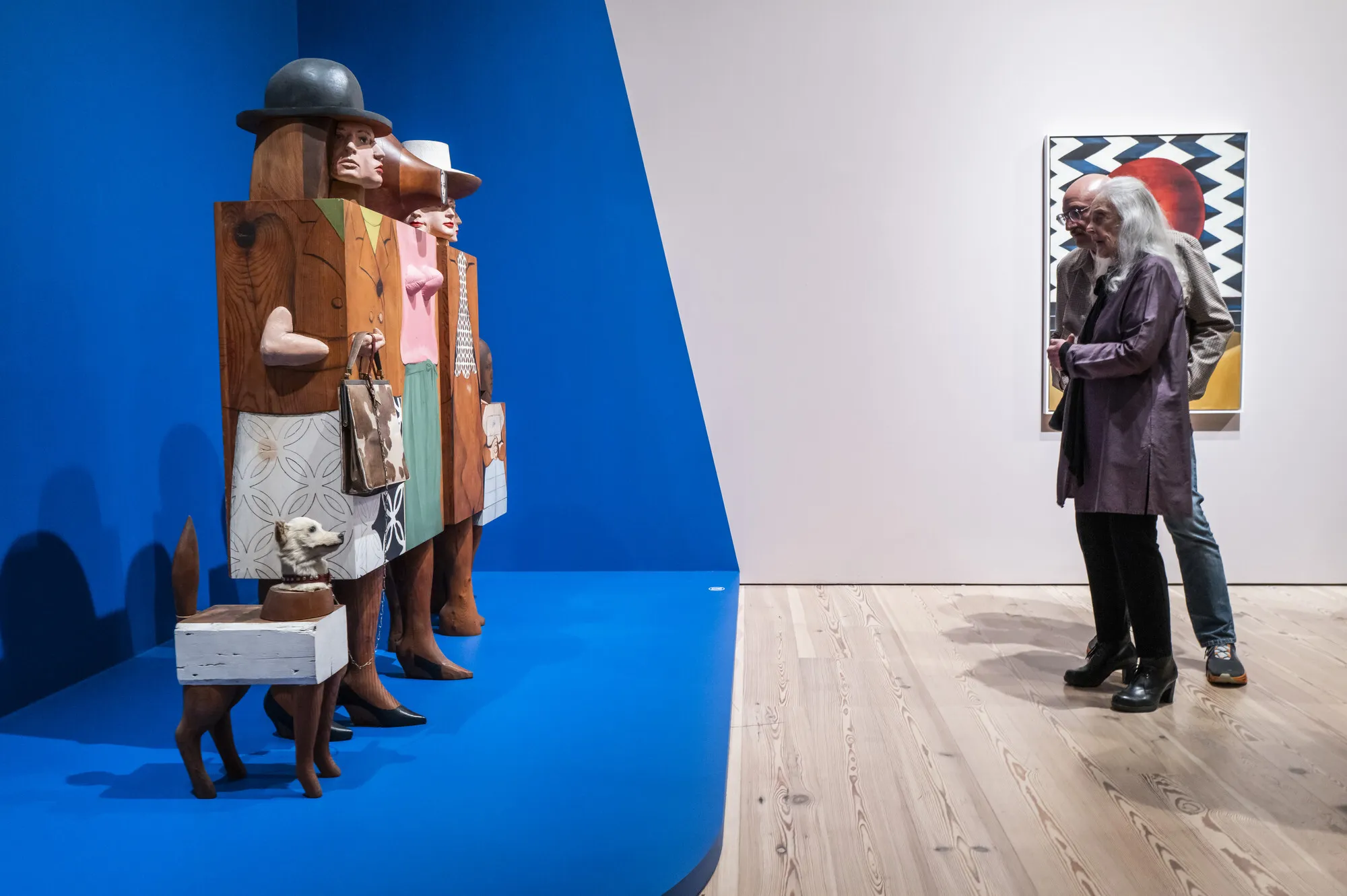 People look at a sculpture in a museum.