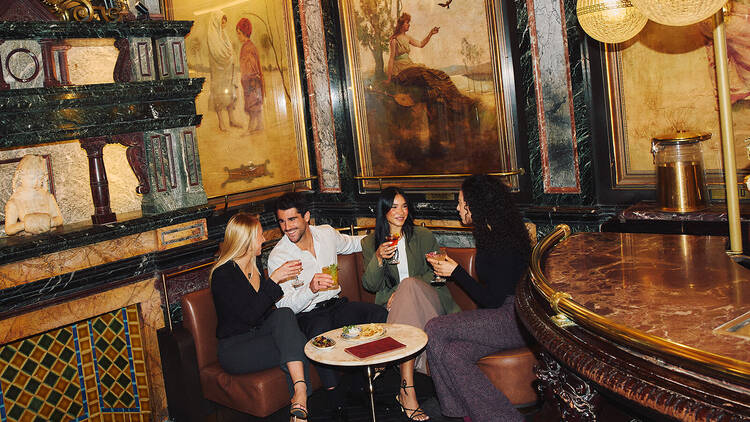 Four people drinking at a heritage bar