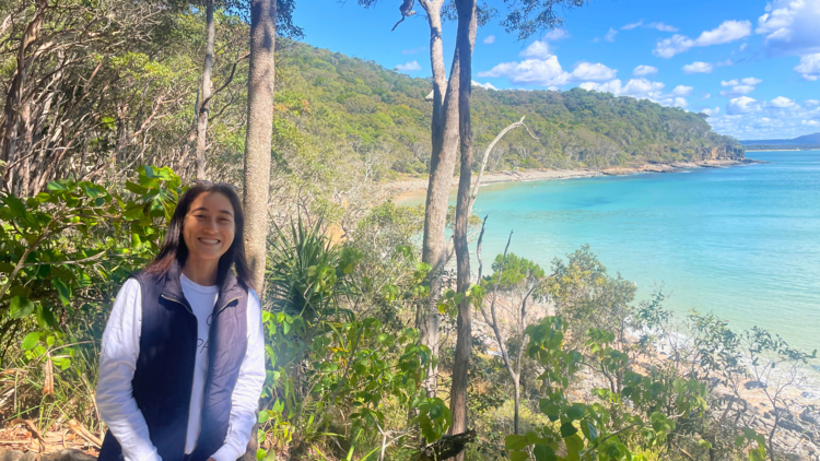 Girl smiling in front of beach
