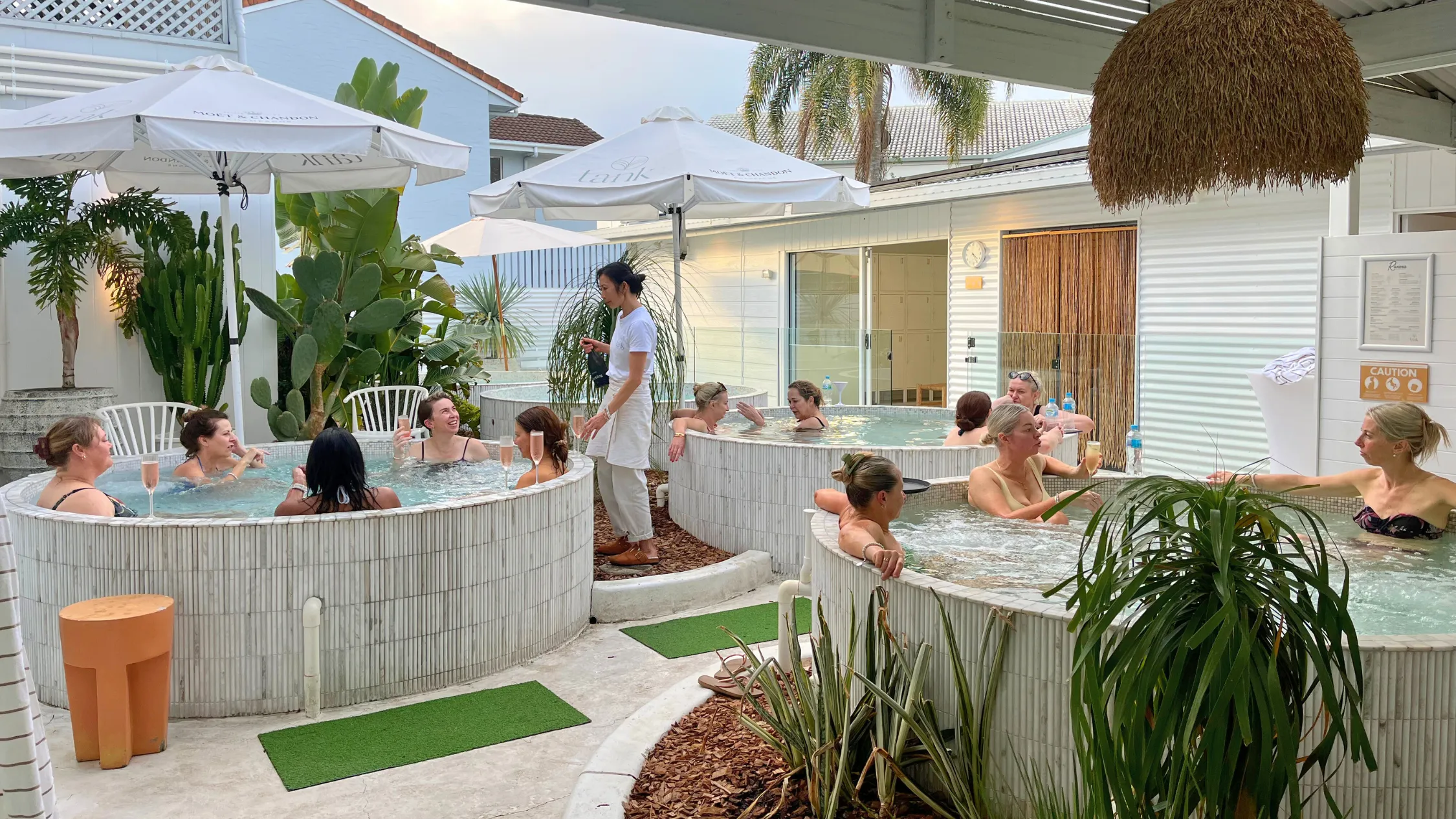Bathhouse with women drinking Champagne