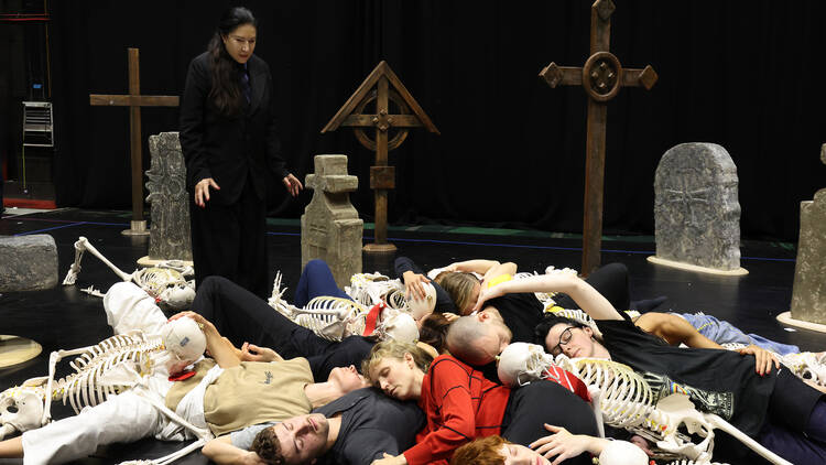 Marina Abramovic standing over the performers during a rehearsal 