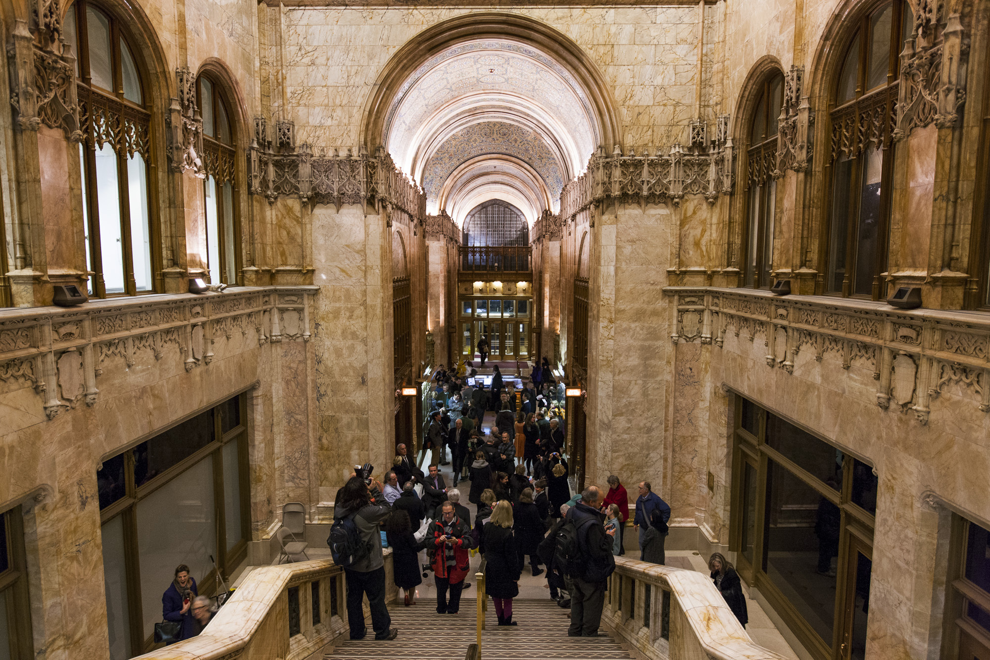 People gather inside the ornate stone lobby of the Woolworth Building.