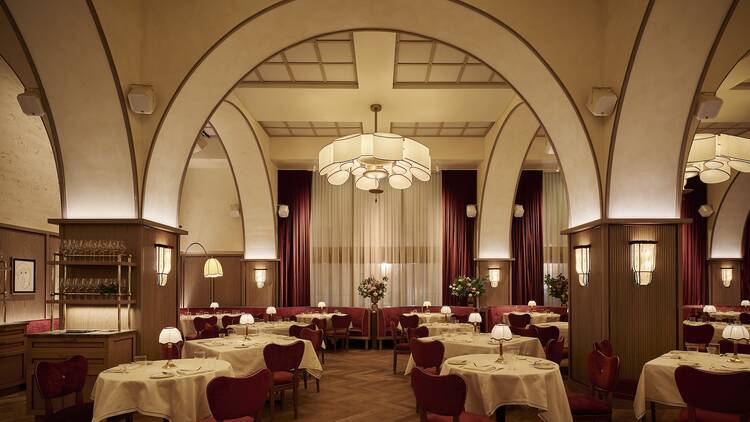 Interior of Crane Club with red chairs and white table cloth