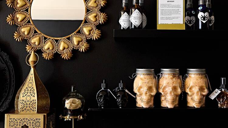 Bath salts in skull jars, dried flowers and more are arranged on shelves at Into The Feral. Bath salts in skull jars, dried flowers and more are arranged on shelves at Into The Feral.