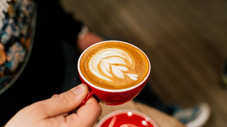 Person holding cup of coffee