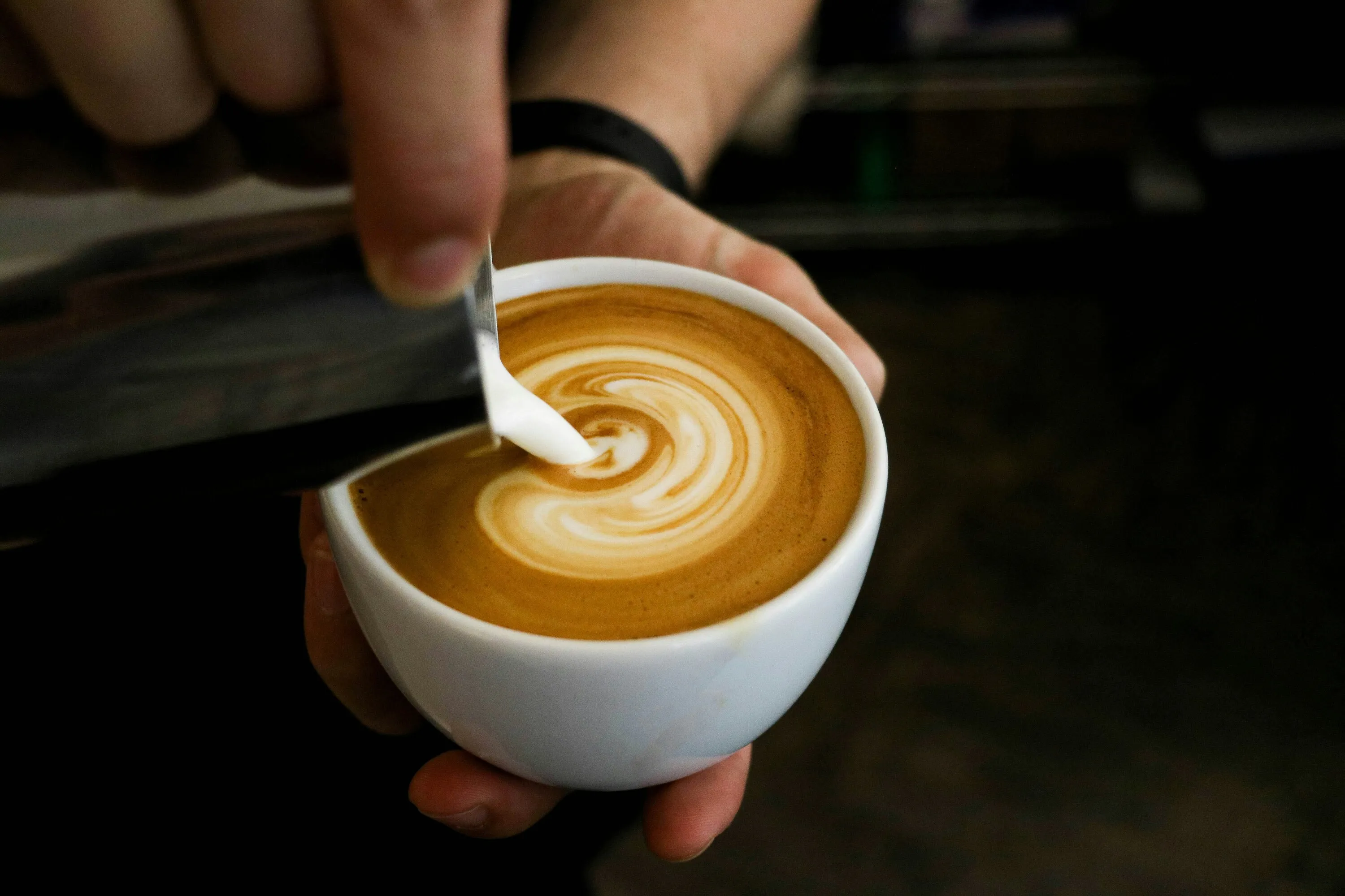 Person pouring cup of coffee