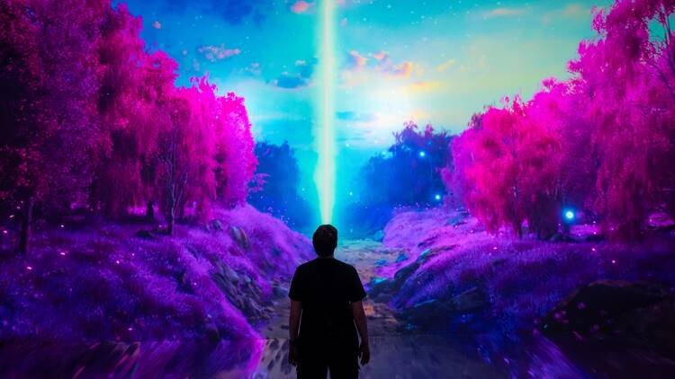 A digital art show of pink trees lining a beaming blue light shooting up into the sky