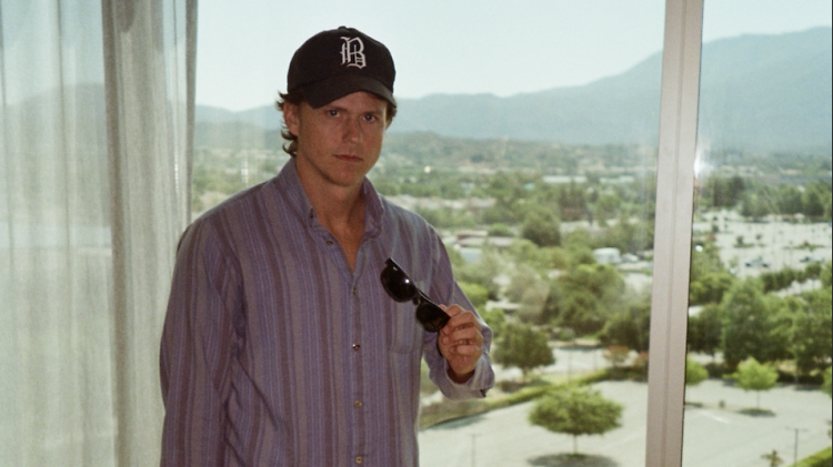 Comedian Whitmer Thomas in a baseball cap.