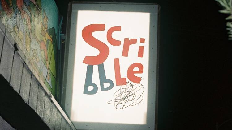 Scribble in Highland Park The sign and exterior of Scribble in Highland Park.