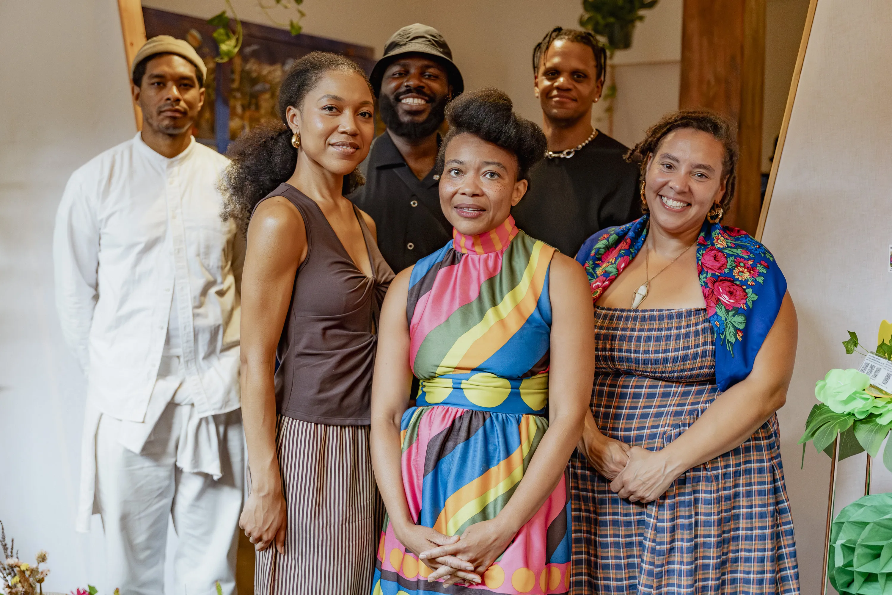 Seven artists stand together for a posed photo.