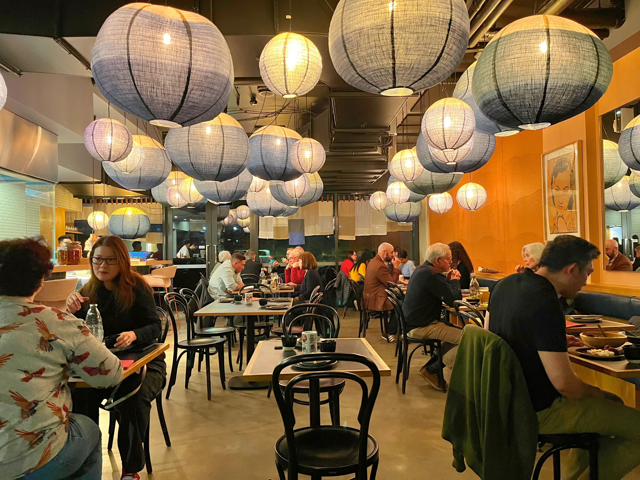 Inside of restaurant dining room with hanging lanterns