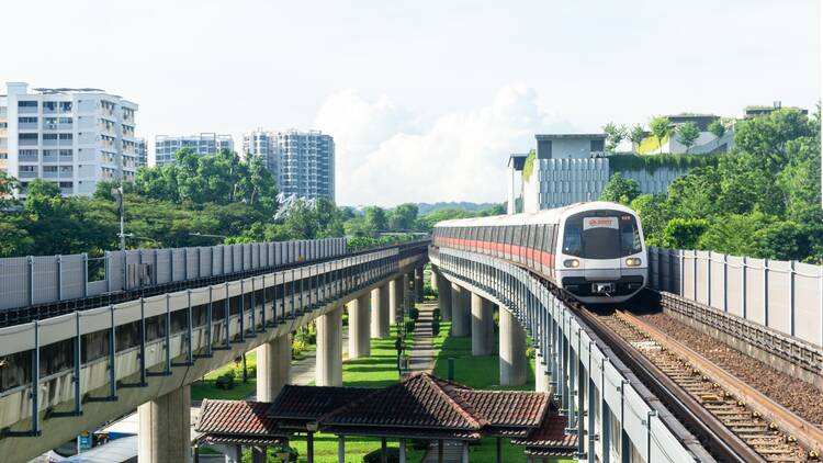 Singapore, 2 November 2024: A modern MRT train approaching a bustling station in Singapore, showcasing efficient public transportation, urban mobility, and sustainable city infrastructure