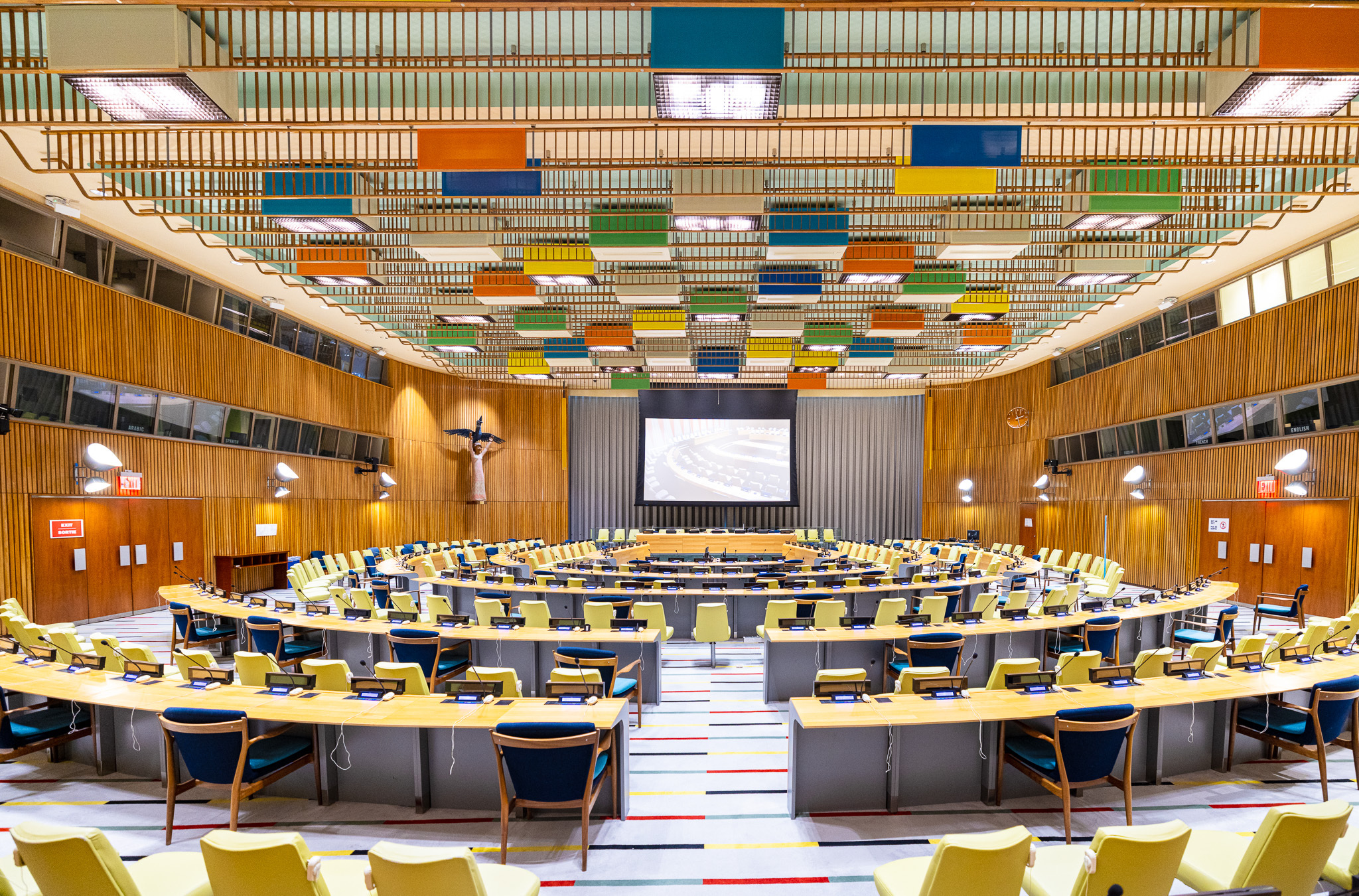 A meeting room with colorful panels on the ceiling.