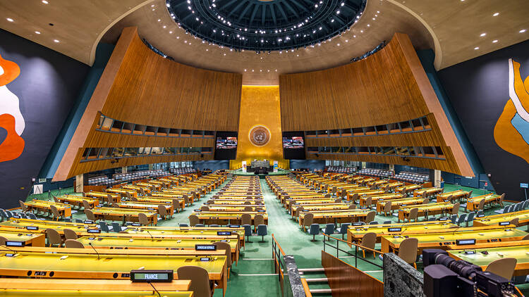 A grand meeting room with many rows of seats.
