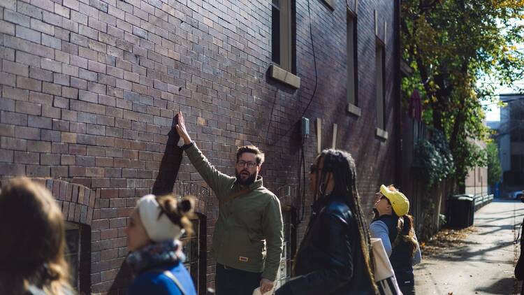 Will Quam conducts a Brick of Chicago tour.