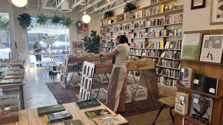 A shopper browsing books at a Good Used Book.