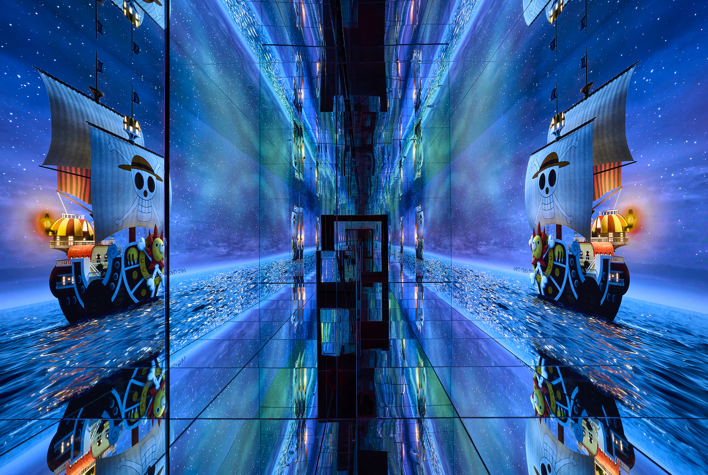 A mirrored wall with blue screens showing a cartoon pirate ship. 