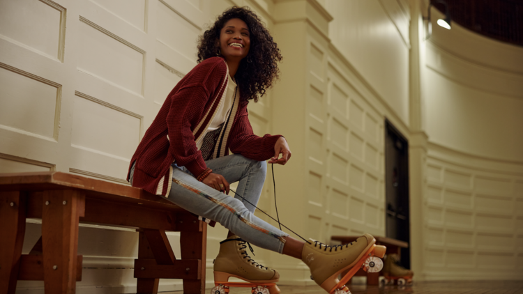 A skater laces up their roller skates at Chicago Athletic Association