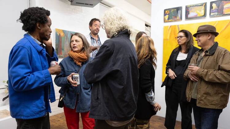 People chatting inside of an art gallery 