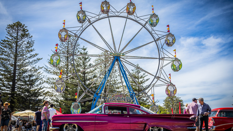 A ferris wheel and classic car