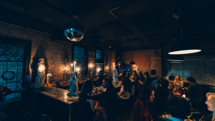 A low-lit bar with a disco ball