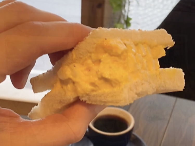 タマゴサンドを頬張り笑顔になる。