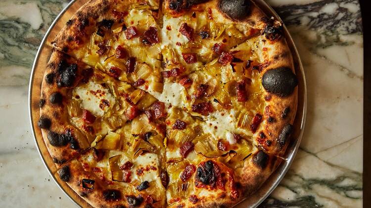 A pizza on a marble counter
