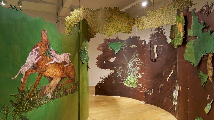 An immersive artwork with paintings of animals and green plants  An immersive artwork with paintings of animals and green plants