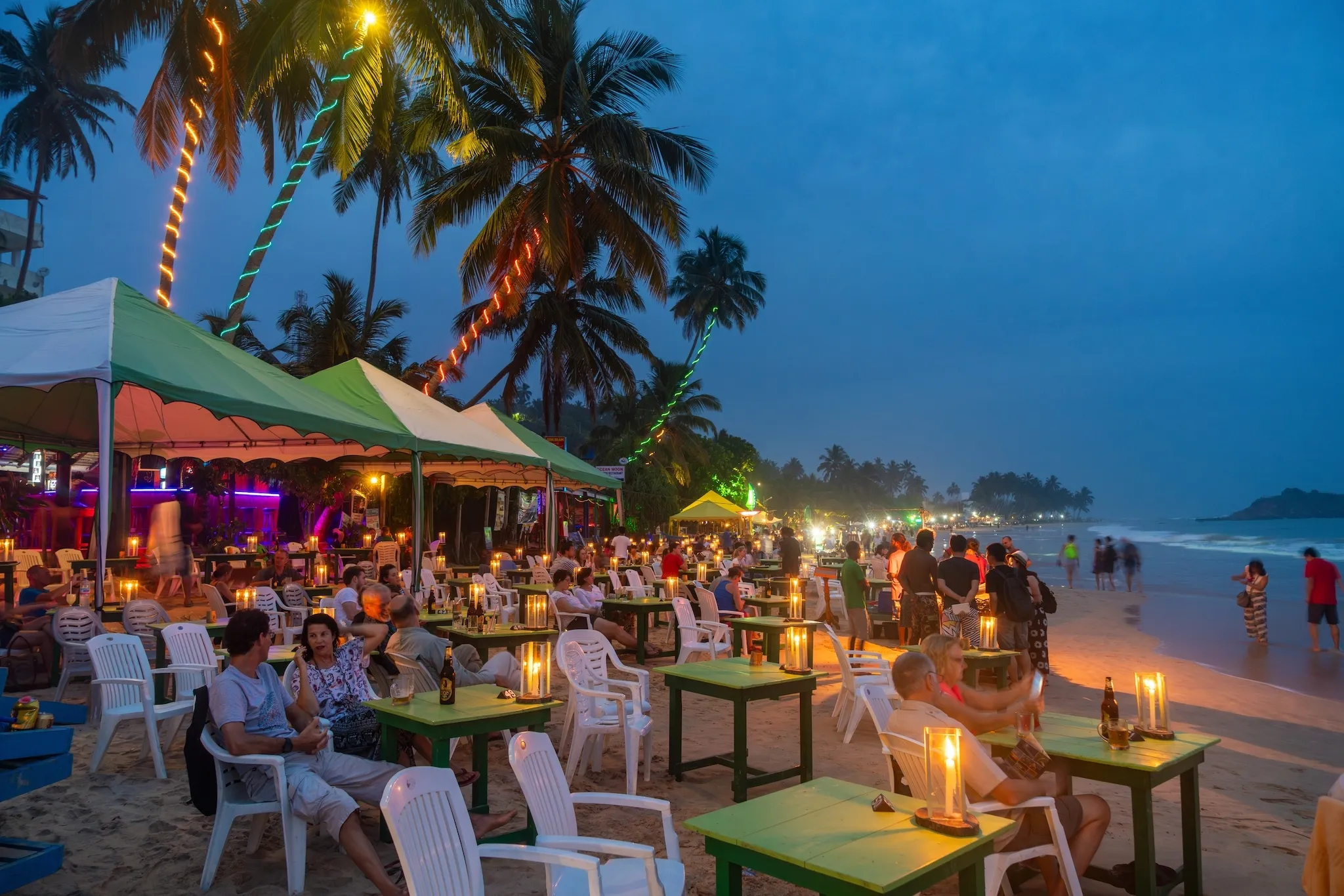 Restaurants on beach at dusk, Mirissa, South Coast, Sri Lanka