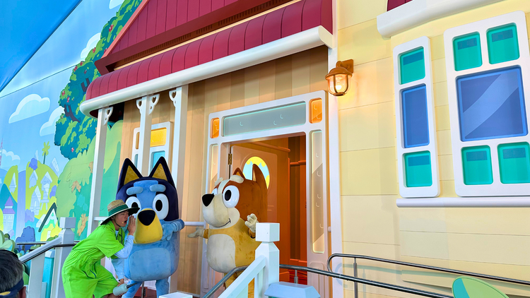 Bluey and Bingo characters outside house