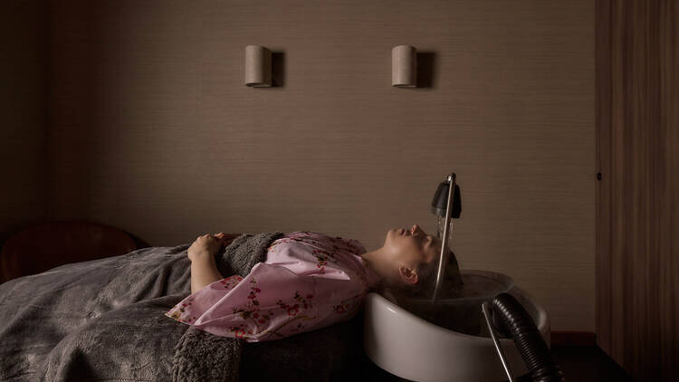 A person enjoying a treatment at Tokyo Headspa.