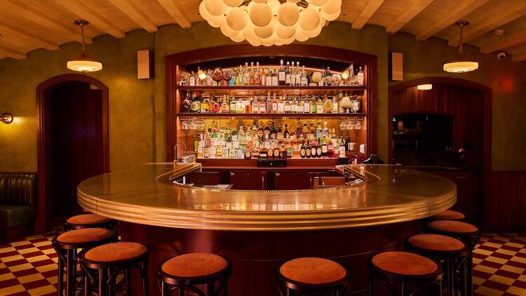 Wild Cherry A horseshoe bar with a globe light fixture above