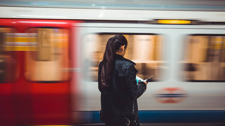 Woman and a London Underground train, UK