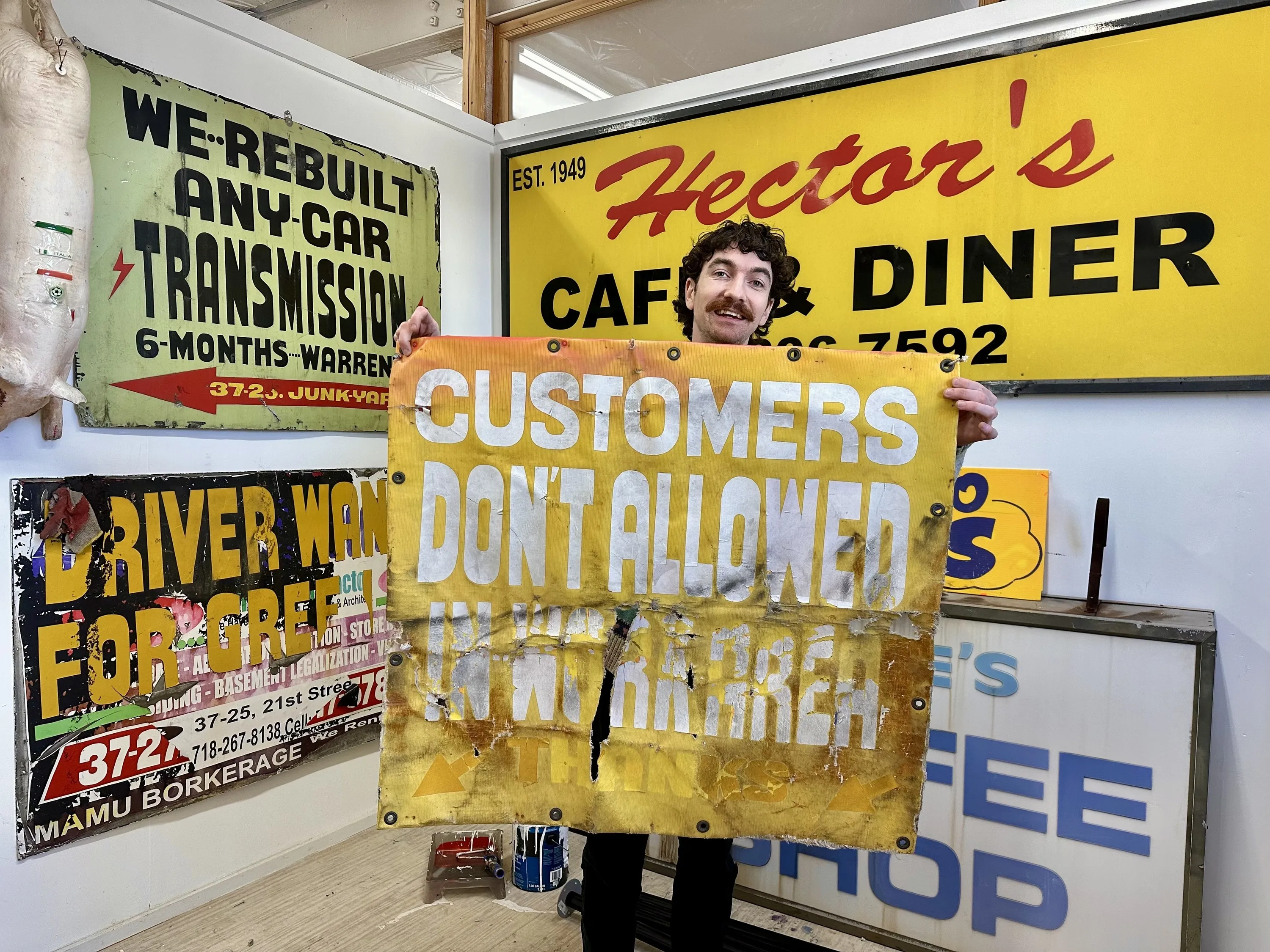 A man holds up a yellow sign.