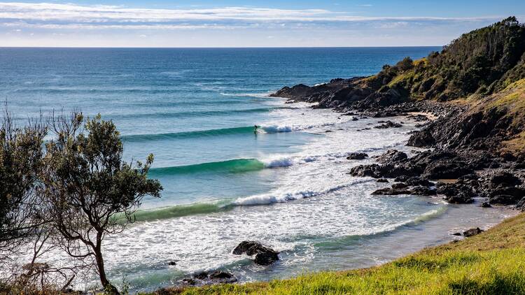 A lone surfer enjoys perfect waves at Crescent Head on the northern side of Racecourse Head.