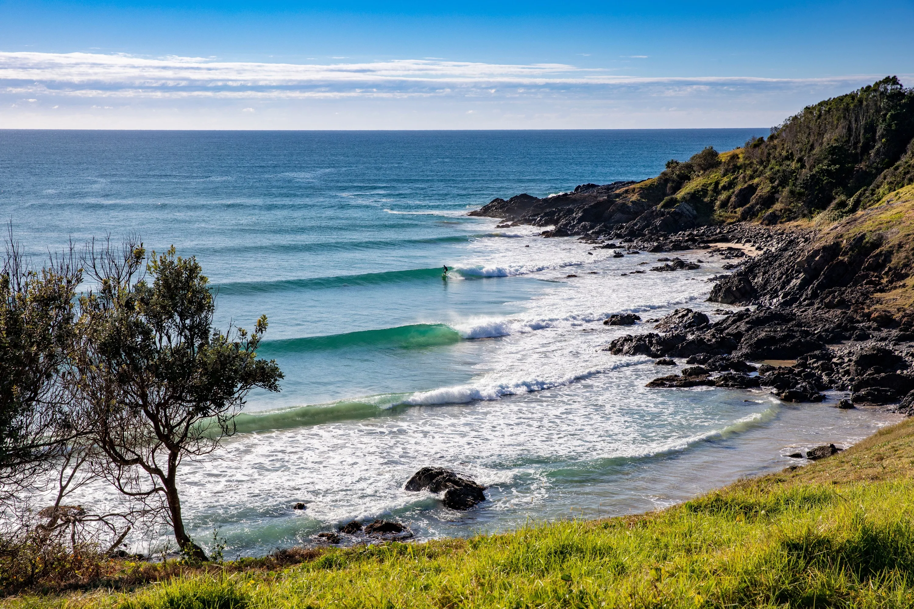 A lone surfer enjoys perfect waves at Crescent Head on the northern side of Racecourse Head.
