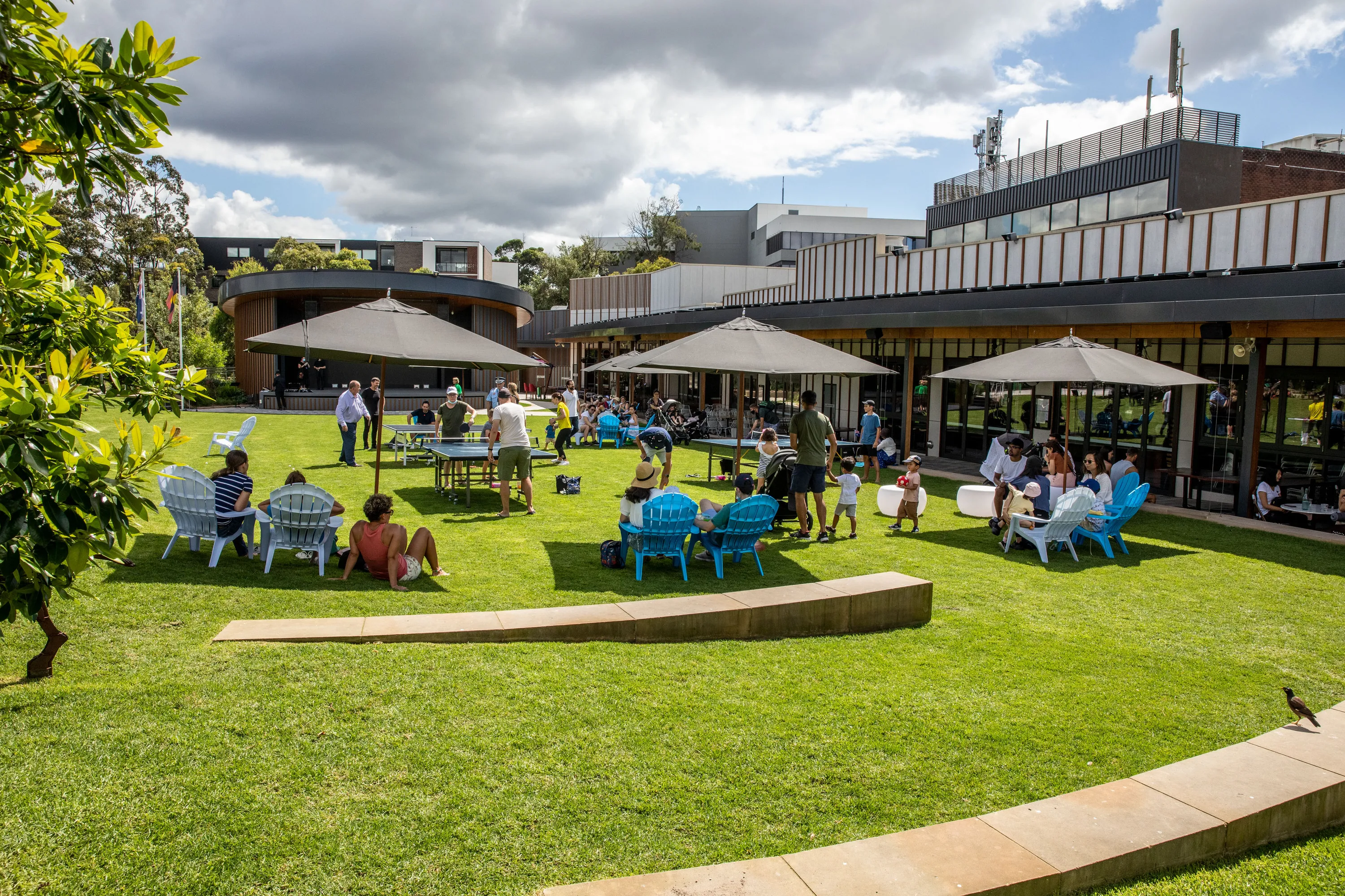 Green area with people seated under umbrellas