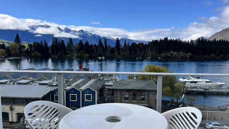 Balcony seating overlooking lake and mountains