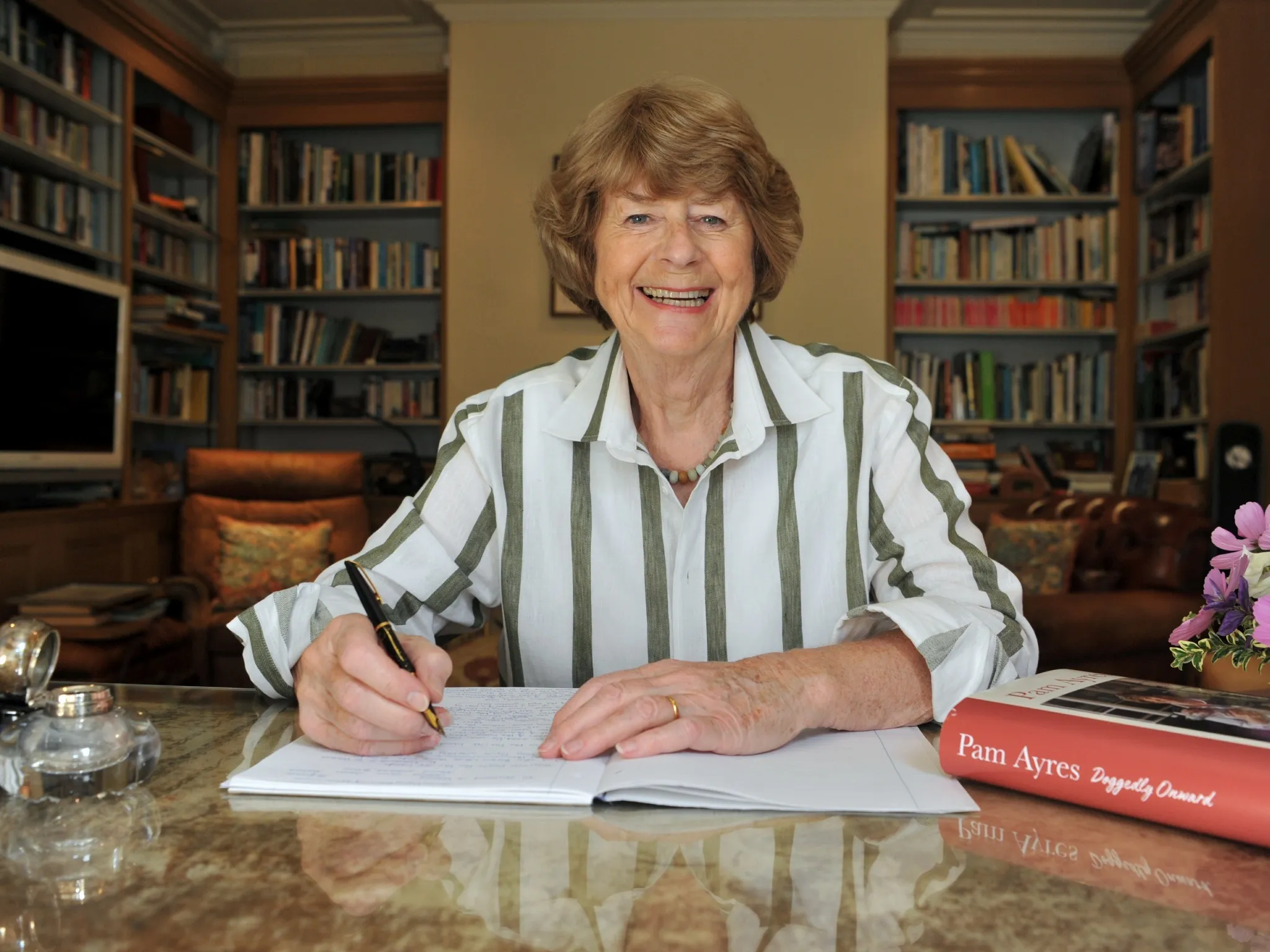 Pay Ayres sitting at her writing desk at home