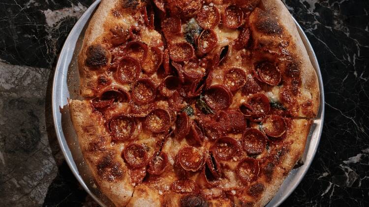 See No Evil Pizza A pizza with pepperonis on it