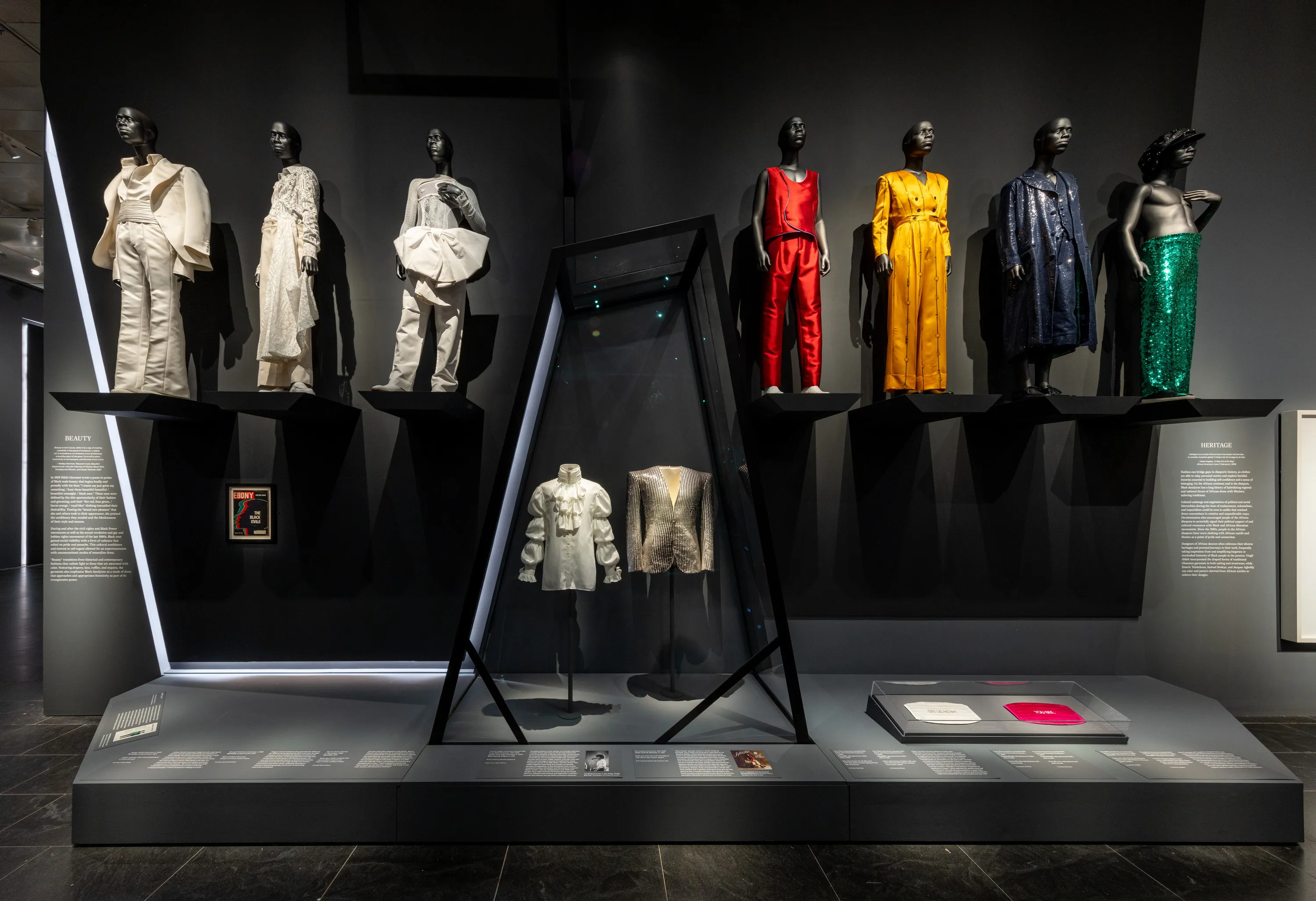 Nine mannequins display a variety of menswear outfits.