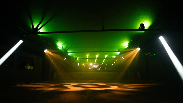 Dark nightclub with green and yellow lights 