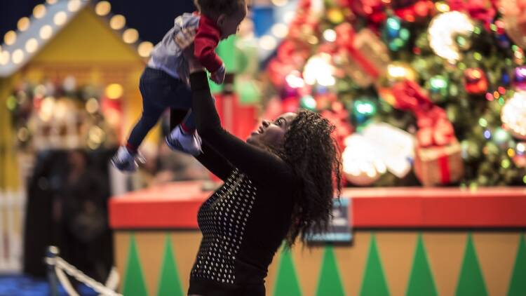 A parent and child enjoy Winter WonderFest at Navy Pier. A parent and child enjoy Winter WonderFest at Navy Pier.