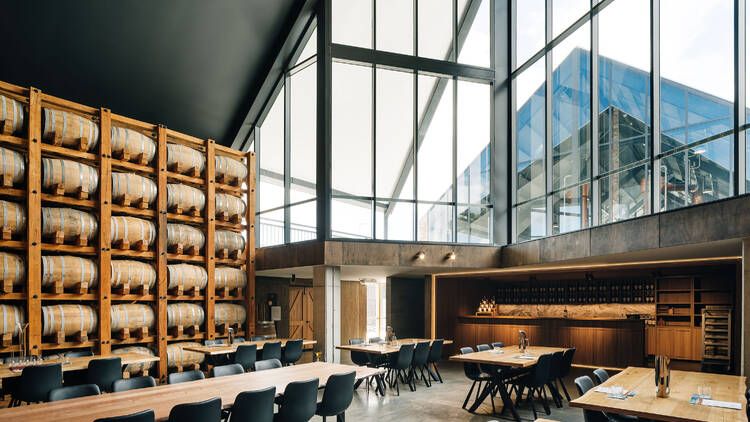 A room with tables, chairs and barrels of whisky
